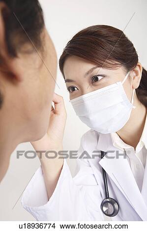 Doctor examining View Large Photo Image Picture - Doctor examining. Fotosearch