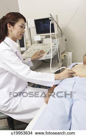 Doctor examining View Large Photo Image Picture - Doctor examining. Fotosearch