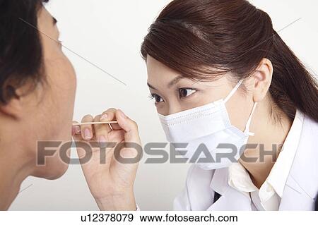 Doctor examining View Large Photo Image Stock Photo - Doctor examining. Fotosearch