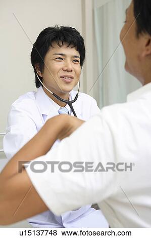 Stock Photo - Doctor examining. Fotosearch