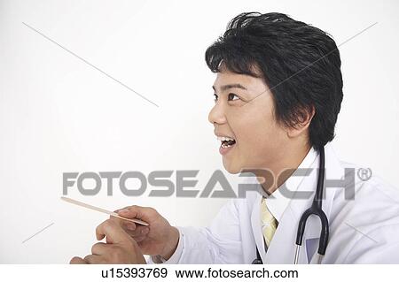 Doctor examining View Large Photo Image Stock Photo - Doctor examining. Fotosearch