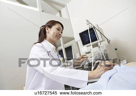 Stock Photography - Doctor examining. Fotosearch