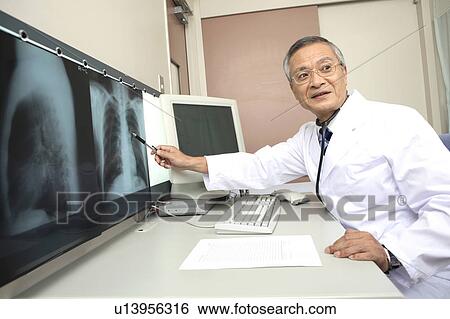 Stock Photograph - Doctor explaining X-ray. Fotosearch