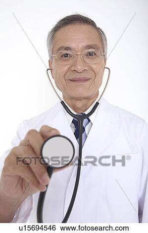 Doctor having a stethoscope View Large Photo Image Stock Photograph - Doctor having a stethoscope. Fotosearch