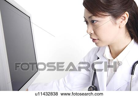 Doctor watching a monitor View Large Photo Image Stock Photo - Doctor watching a monitor. Fotosearch