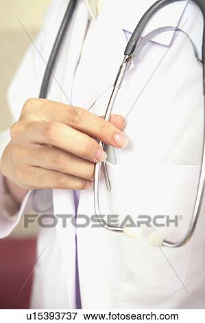 Stock Photo - Hand having a stethoscope. Fotosearch