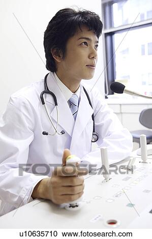 Physician operating a machine View Large Photo Image Stock Image - Physician operating a machine. Fotosearch