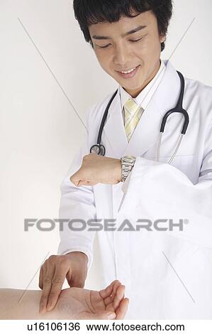 Physician taking the pulse View Large Photo Image Stock Photograph - Physician taking the pulse. Fotosearch