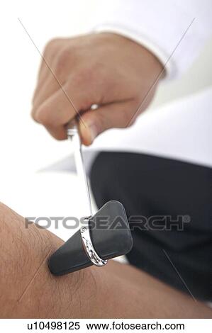 Stock Photography - Hand checking out knee. Fotosearch