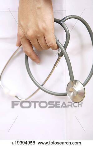 Stock Photo - Hand having a stethoscope. Fotosearch