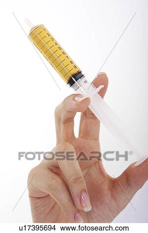 Picture - Hand having a syringe. Fotosearch