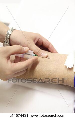 Stock Image - Hand having a syringe. Fotosearch