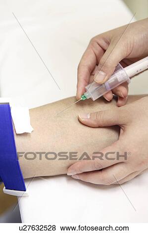 Stock Photo - Hand having a syringe. Fotosearch