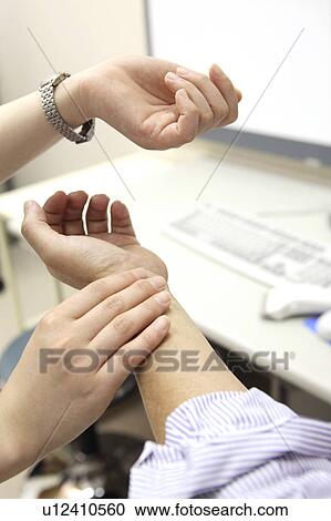 Stock Image - Hand measuring a pulse. Fotosearch
