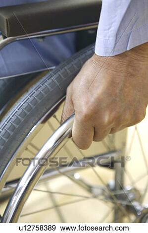Hand rowing a wheelchair View Large Photo Image Stock Photo - Hand rowing a wheelchair. Fotosearch