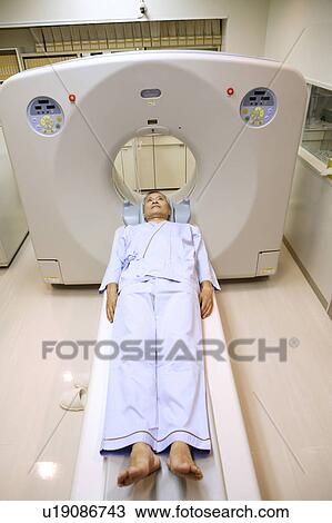 Stock Image - Man examined by a CT scanning. Fotosearch