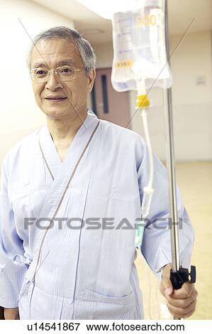 Man receiving intravenous feeding View Large Photo Image Stock Photo - Man receiving intravenous feeding. Fotosearch