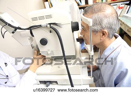 Stock Photo - Man taking an eye test. Fotosearch