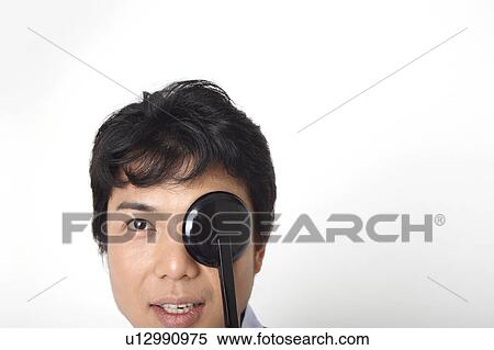 Man taking an eye test View Large Photo Image Stock Photography - Man taking an eye test. Fotosearch