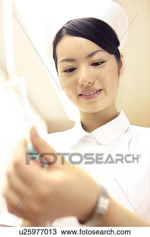 Nurse checking intravenous feeding View Large Photo Image Stock Image - Nurse checking intravenous feeding. Fotosearch