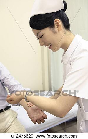 Nurse measuring a pulse View Large Photo Image Stock Image - Nurse measuring a pulse. Fotosearch