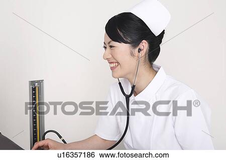 Nurse measuring blood pressure View Large Photo Image Stock Photograph - Nurse measuring blood pressure. Fotosearch