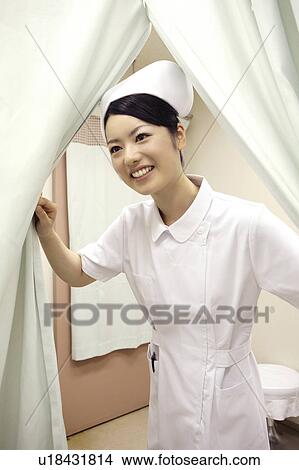 Nurse opening a curtain View Large Photo Image Picture - Nurse opening a curtain. Fotosearch