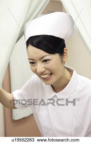 Nurse opening a curtain View Large Photo Image Stock Image - Nurse opening a curtain. Fotosearch