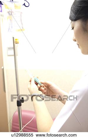 Stock Photography - Nurse preparing for the intravenous feeding. Fotosearch