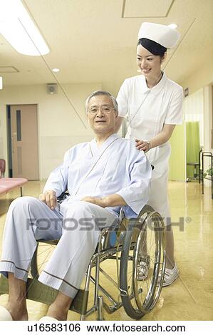 Nurse pushing the wheelchair View Large Photo Image Stock Photograph - Nurse pushing the wheelchair. Fotosearch