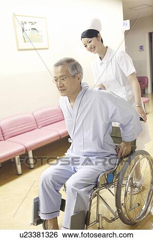 Stock Photograph - Nurse pushing the wheelchair. Fotosearch