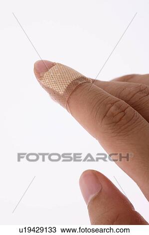 Stock Image - Finger with Band-Aid. Fotosearch