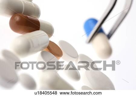 Stock Photo - Tweezers and tablet. Fotosearch