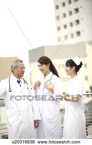 Doctor and nurse having a chat View Large Photo Image Stock Photo - Doctor and nurse having a chat. Fotosearch