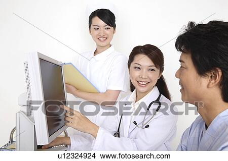 Doctor explaining by a monitor View Large Photo Image Picture - Doctor explaining by a monitor. Fotosearch
