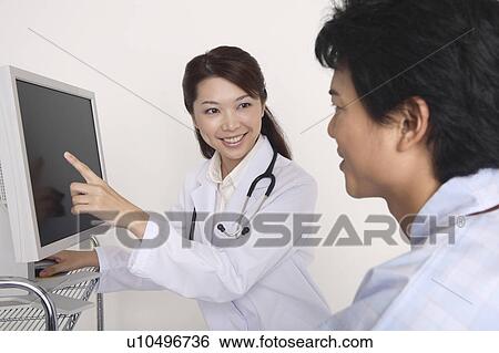 Stock Photograph - Doctor explaining to a patient. Fotosearch
