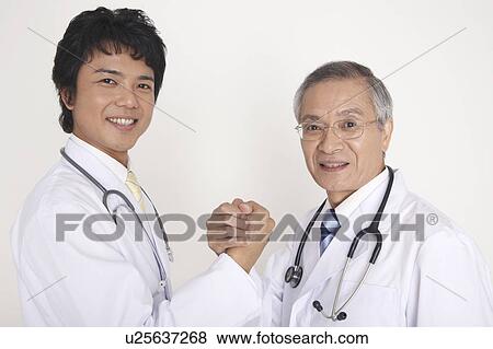 Physician taking each other's hands View Large Photo Image Stock Photo - Physician taking each other's hands. Fotosearch