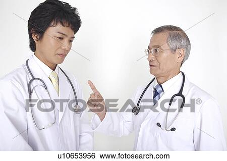 Physician teaching young physician View Large Photo Image Stock Photograph - Physician teaching young physician. Fotosearch