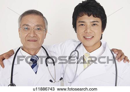 Physicians crossing a shoulder View Large Photo Image Stock Image - Physicians crossing a shoulder. Fotosearch