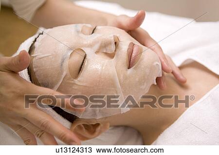 Woman applying a pack to her face View Large Photo Image Stock Image - Woman applying a pack to her face. Fotosearch