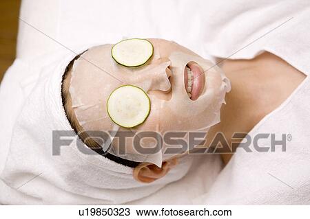 Woman applying a pack to her face View Large Photo Image Stock Image - Woman applying a pack to her face. Fotosearch