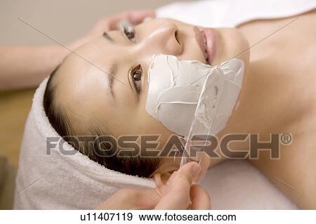 Woman applying a pack to her face View Large Photo Image Stock Photo - Woman applying a pack to her face. Fotosearch