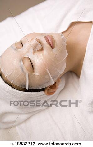 Woman applying a pack to her face View Large Photo Image Stock Photo - Woman applying a pack to her face. Fotosearch