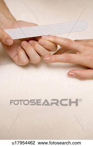 Woman taking a manicure at beauty-treatment clinic View Large Photo Image Stock Image - Woman taking a manicure at beauty-treatment clinic. Fotosearch
