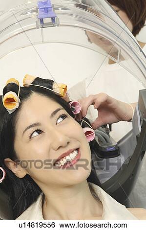 Stock Photograph - Woman to have a perm. Fotosearch