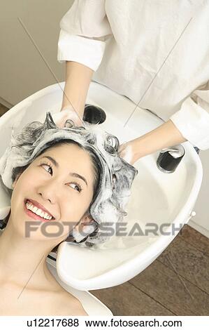 Stock Photo - Woman who does a shampoo. Fotosearch