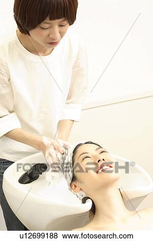 Woman who does a shampoo View Large Photo Image Stock Photo - Woman who does a shampoo. Fotosearch