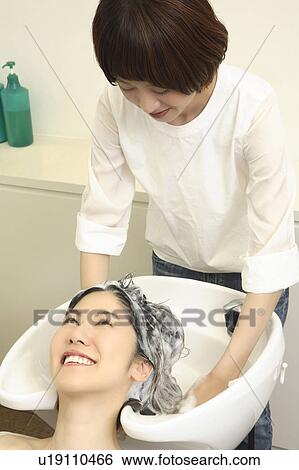 Woman who does a shampoo View Large Photo Image Stock Photograph - Woman who does a shampoo. Fotosearch