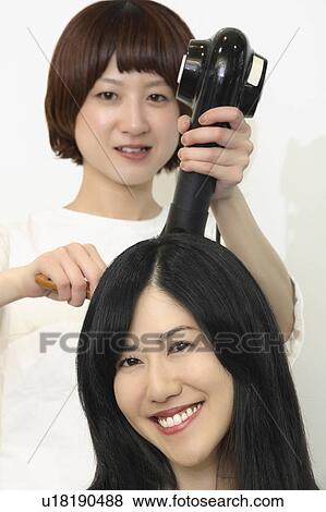 Woman who dries hair View Large Photo Image Stock Photo - Woman who dries hair. Fotosearch