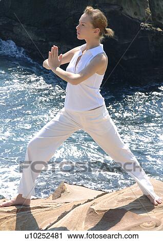 Side profile of a young woman practicing yoga View Large Photo Image Stock Image - Side profile of a young woman practicing yoga. Fotosearch
